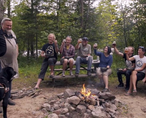 Ottawa River Champions, Lawrence and featured Chef Steve Mitton sit around the camp fire